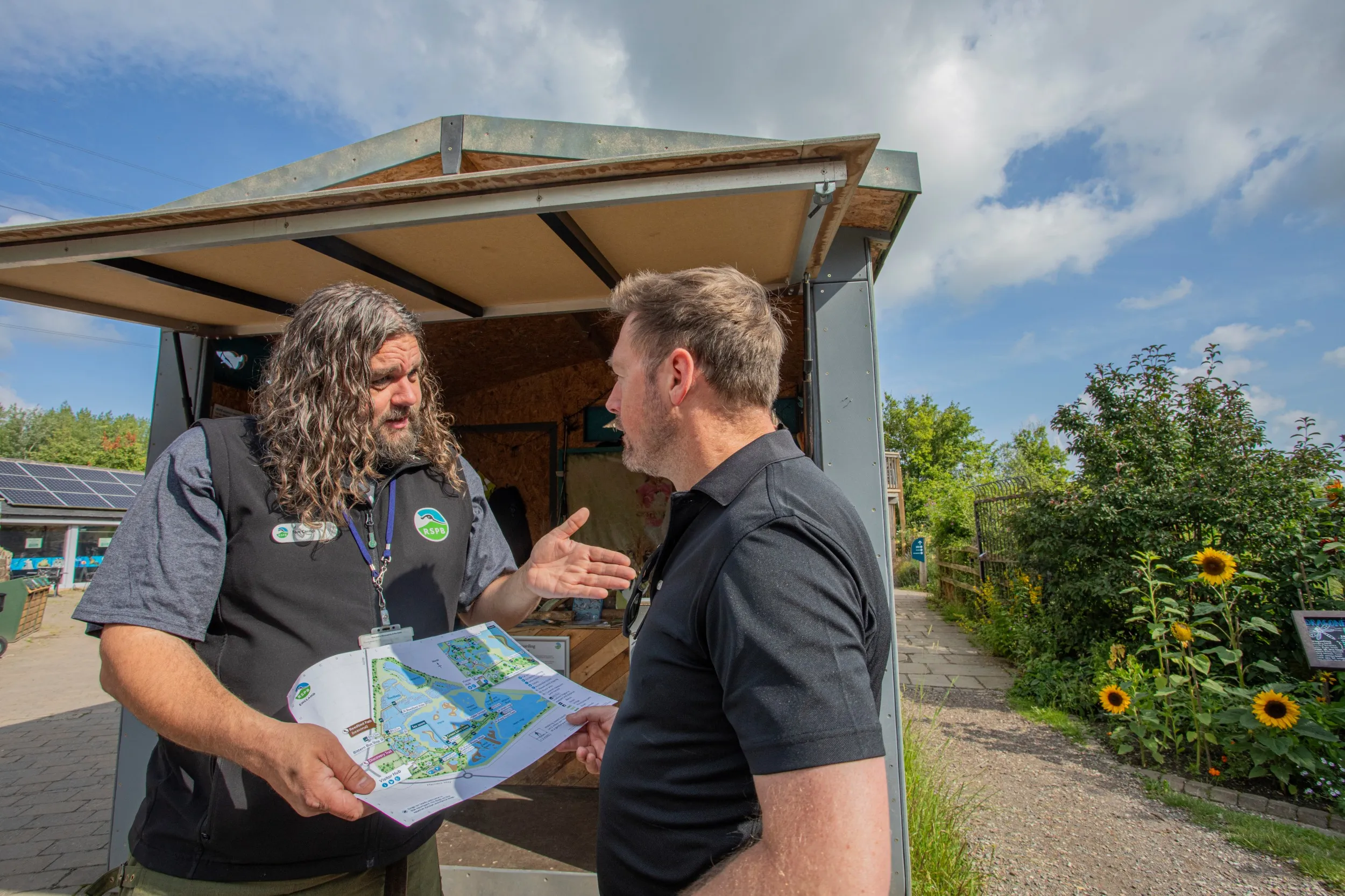Tom Carrick, Face to Face Membership Specialist Fundraiser speaking to a visitor at RSPB Old Moor Nature Reserve,