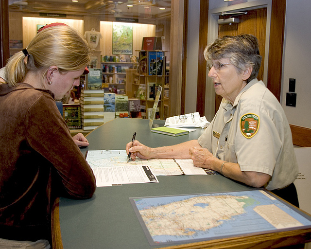 Volunteer and visitor looking at a park map