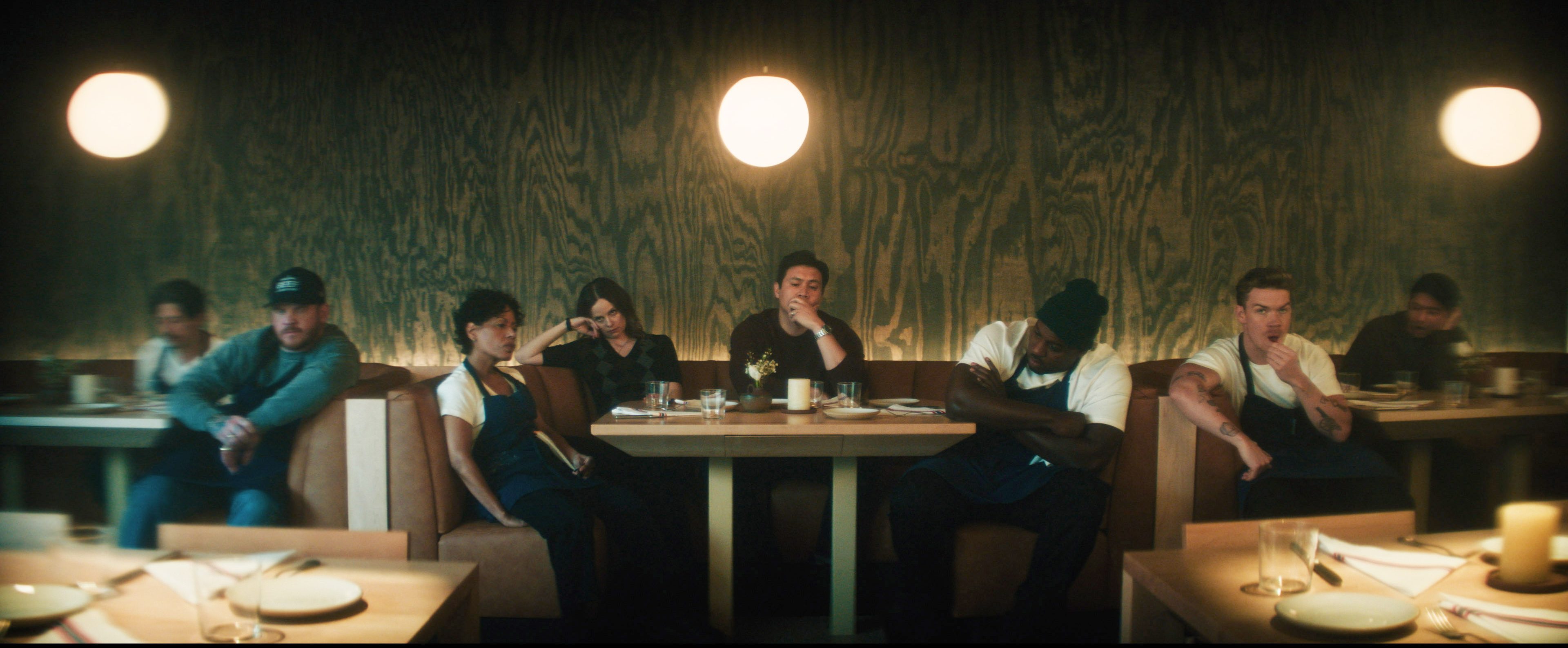 The Bear's staff assemble ahead of a daunting night. From left: Chris Zucchero as Chi-Chi, Paulie James as Chuckie, Liza Colón-Zayas as Tina, Sarah Ramos as Jessica, Rene Gube as Rene, Lionel Boyce as Marcus, Will Poulter as Luca and Andrew Lopez as Garrett in Season 5 of "The Bear."