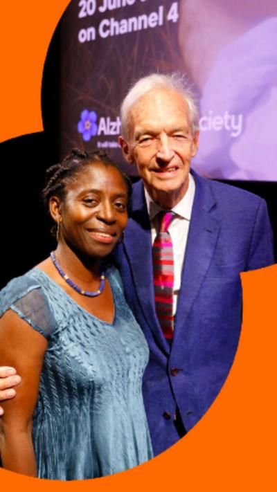 Dr Precious Lunga (left), wearing a blue dress and Jon Snow (right) wearing a blue suit.