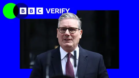 An image of Keir Starmer wearing a navy suit and purple tie in front of a blue square background.