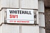 Whitehall street sign mounted on a stone building wall in London.