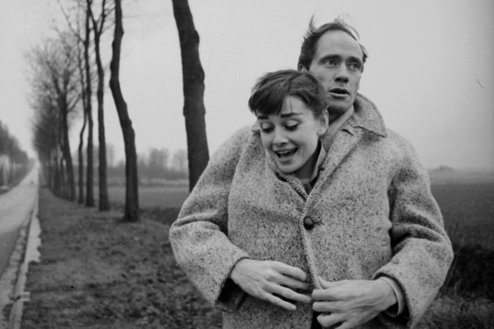 Image may contain Audrey Hepburn Mel Ferrer Face Head Person Photography Portrait Clothing Coat and Knitwear