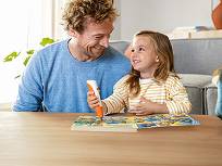 Vater schaut mit Kind tiptoi Buch an