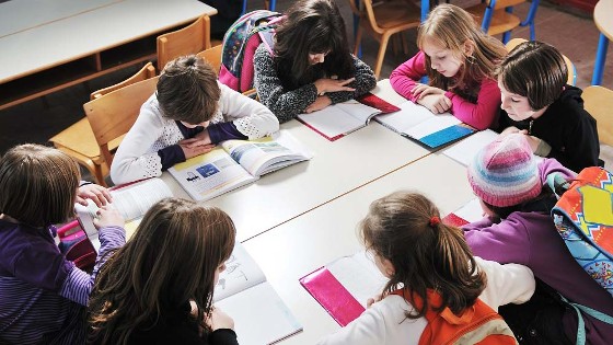 kids sitting around a white table