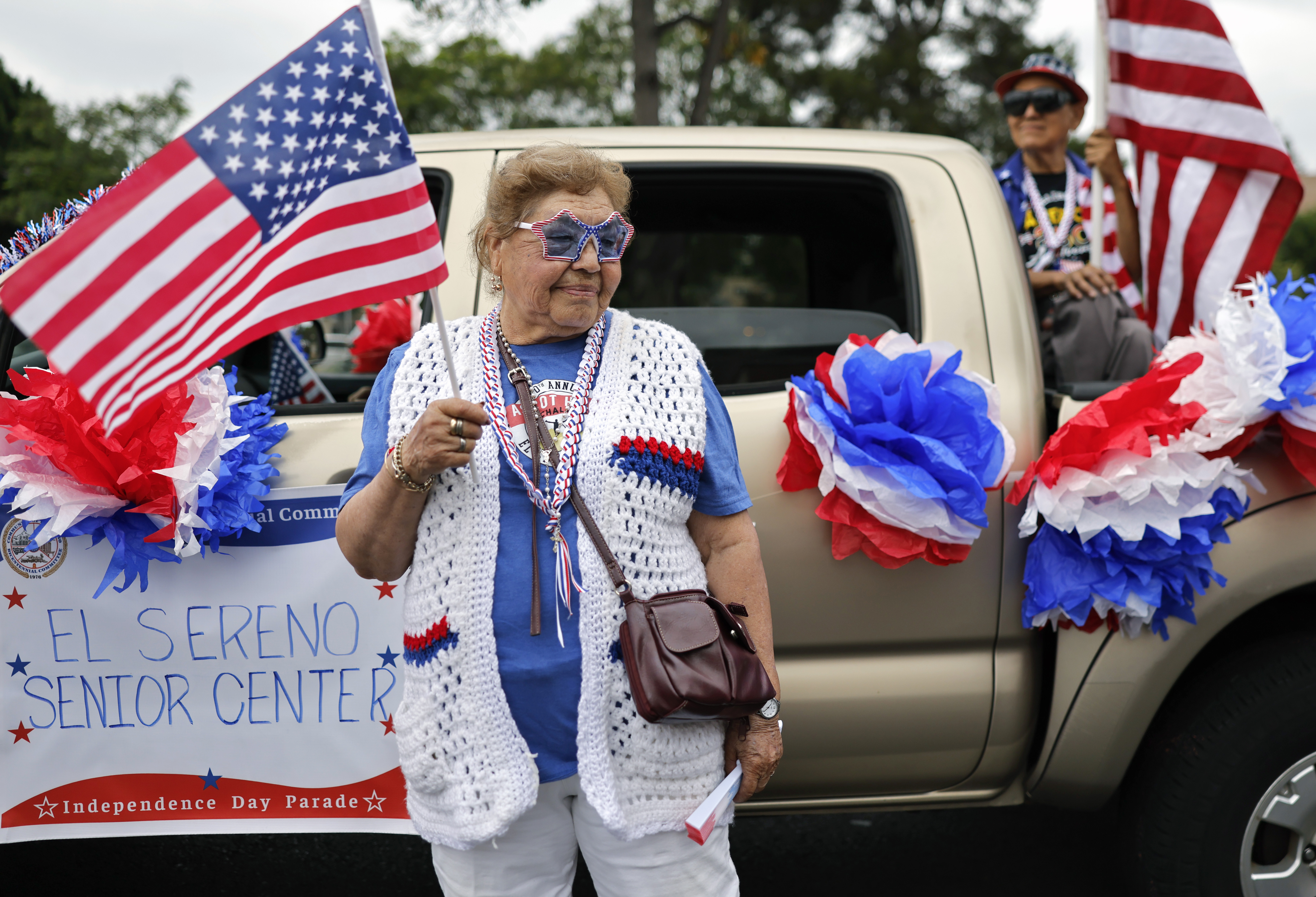 Participants hold American flags before the 67th annual El Sereno Independence Day Parade in the predominantly Latino community of El Sereno on June 27, 2026, in Los Angeles. This year's theme was "100 Years of Route 66," and the parade was canceled last year due to safety concerns amid widespread immigration raids across the city. People around the nation are gearing up for America's 250th anniversary, which will be marked on July 4, 2026, commemorating the signing of the Declaration of Independence. (Mario Tama/Getty)