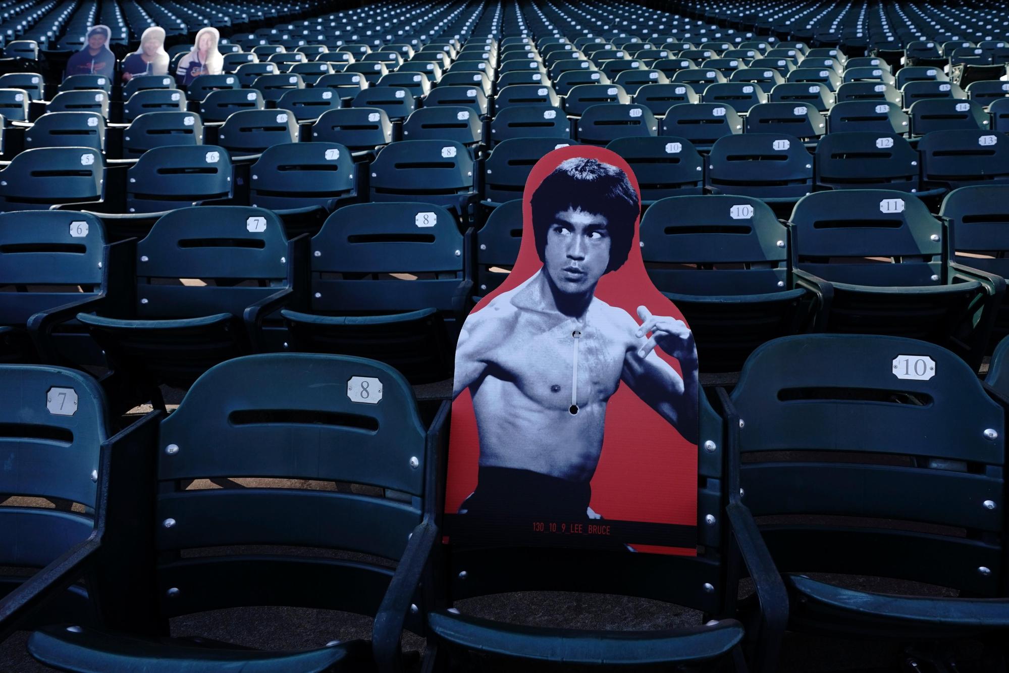 FILE – A cardboard cutout of martial artist Bruce Lee is displayed at Oracle Park before a baseball game between the San Francisco Giants and the San Diego Padres in San Francisco, July 30, 2020. (AP Photo/Jeff Chiu, File)
