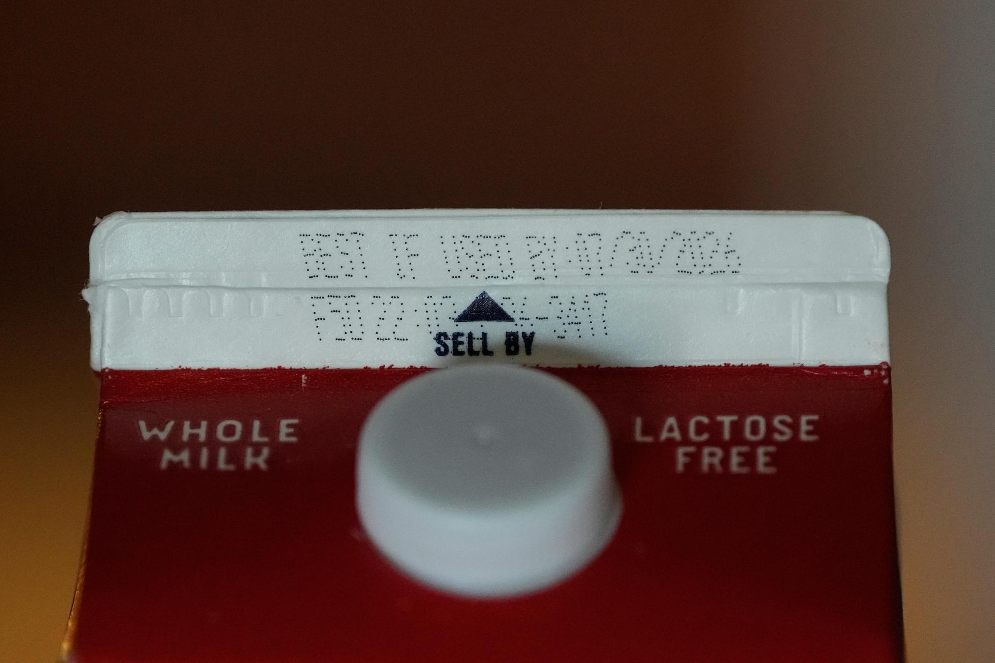 A Best If Used By date is stamped above a Sell By label on a milk carton, Tuesday, June 30, 2026, in San Francisco. (AP Photo/Jeff Chiu)
