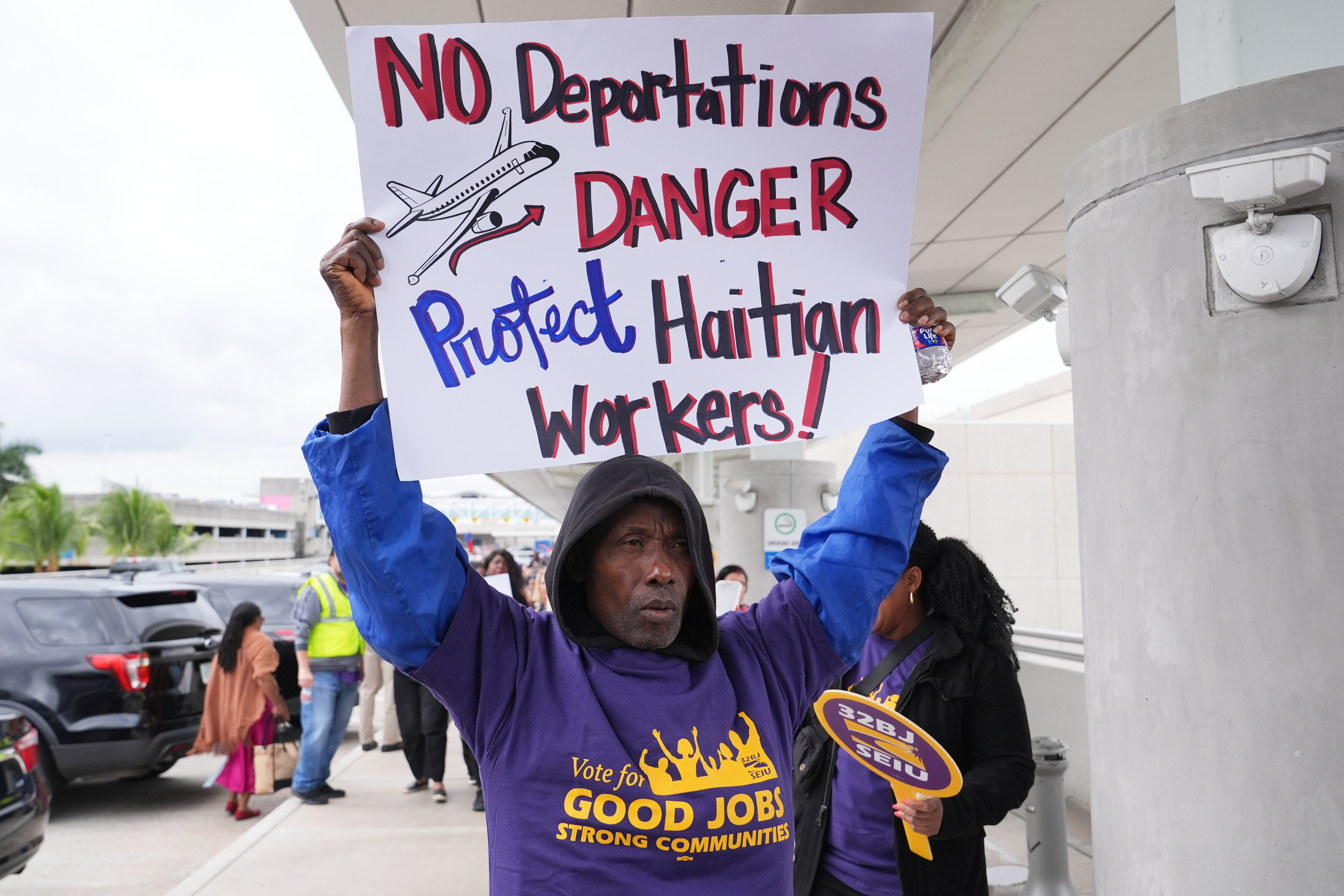 A person marches during a rally in support of the extension of Temporary Protected Status (TPS) for Haitian immigrants before it expires on February 3, Wednesday, Jan. 28, 2026, in Fort Lauderdale, Fla. (AP Photo/Lynne Sladky)