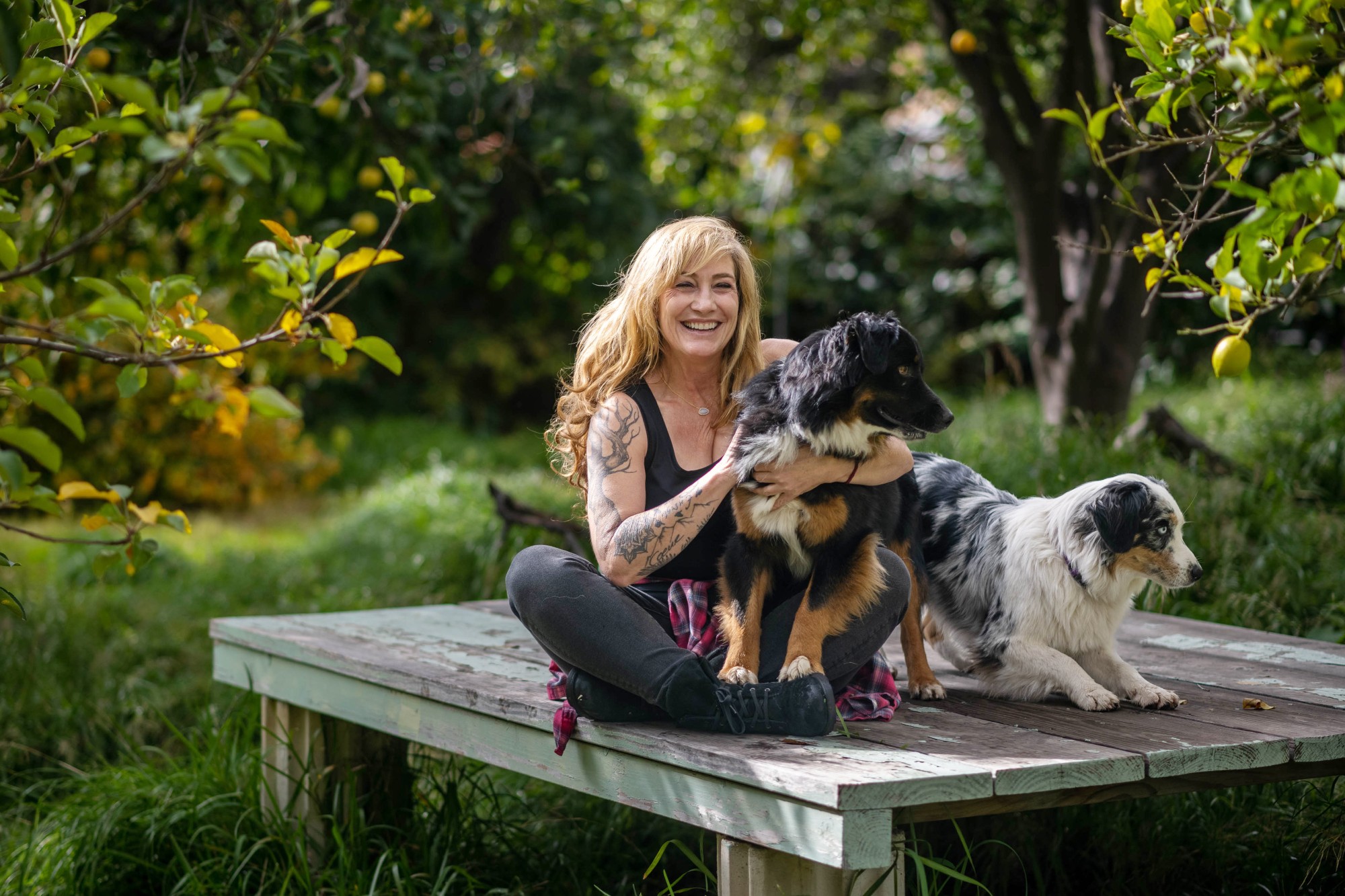 Author and Chaffey College journalism professor Michelle Dowd enjoys a nice day in her backyard with dogs, Cedar, left, and Edith. Dawd’s “Memoir Forager: Field Notes for Surviving a Family Cult” will be released March 7, 2023. (Photo by Watchara Phomicinda, The Press-Enterprise/SCNG)
