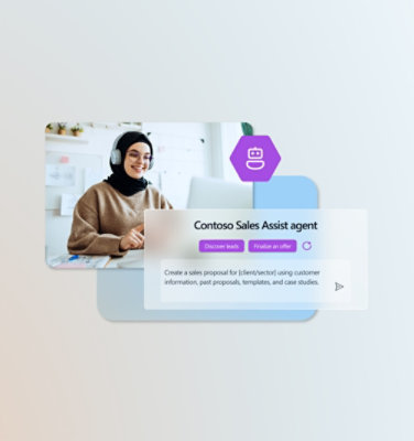 Seorang perempuan sedang duduk mengenakan headphone di depan laptop di dalam ruang kantor