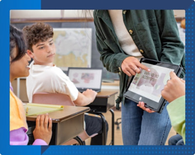 O persoană care ține o tabletă cu un grup de elevi în fundal