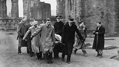 1950s archive photo of police and others carrying the Stone of Destiny at the handover of the stone at Arbroath Abbey (Credit: Alamy)