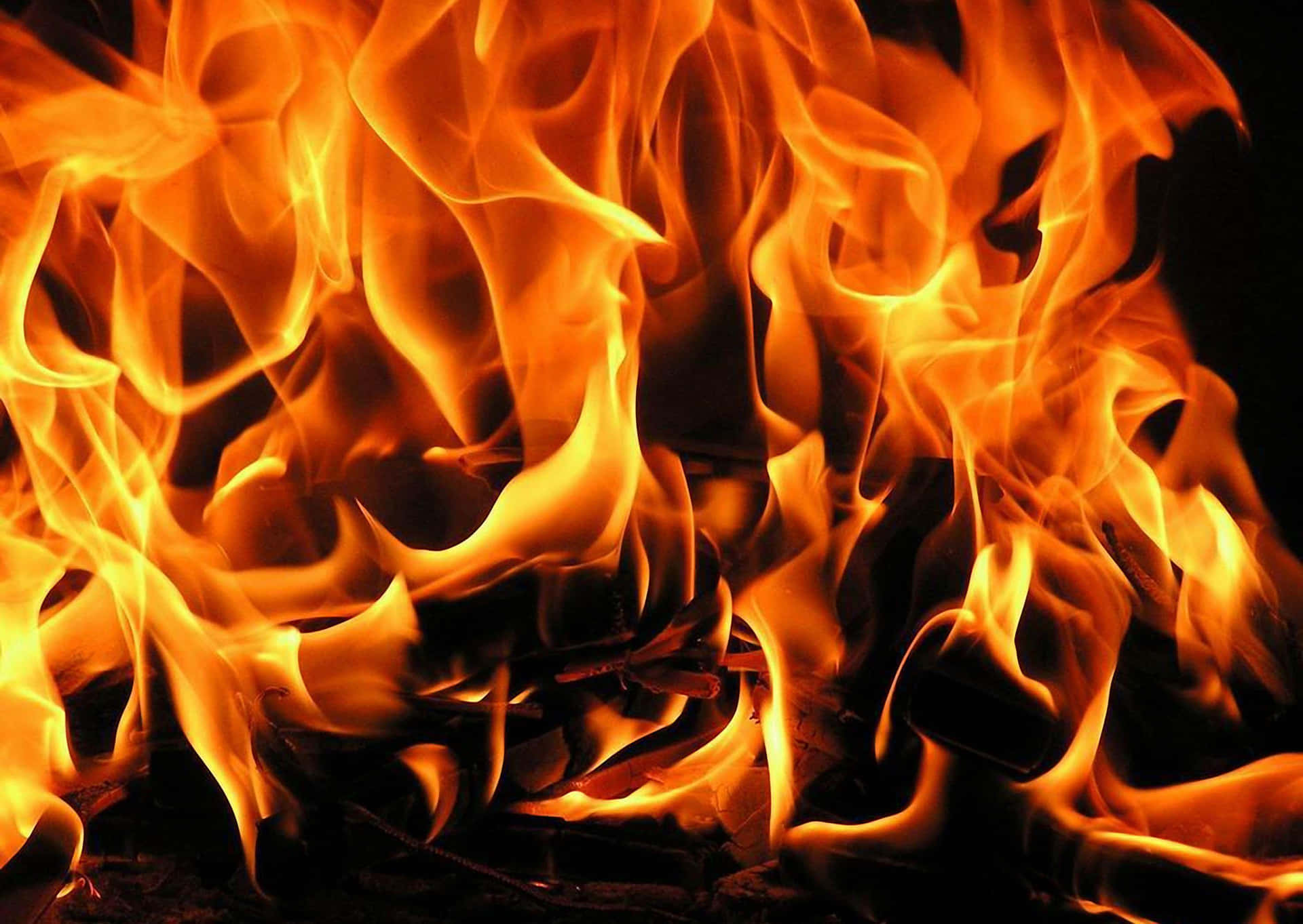 a close up of a fire with flames Wallpaper