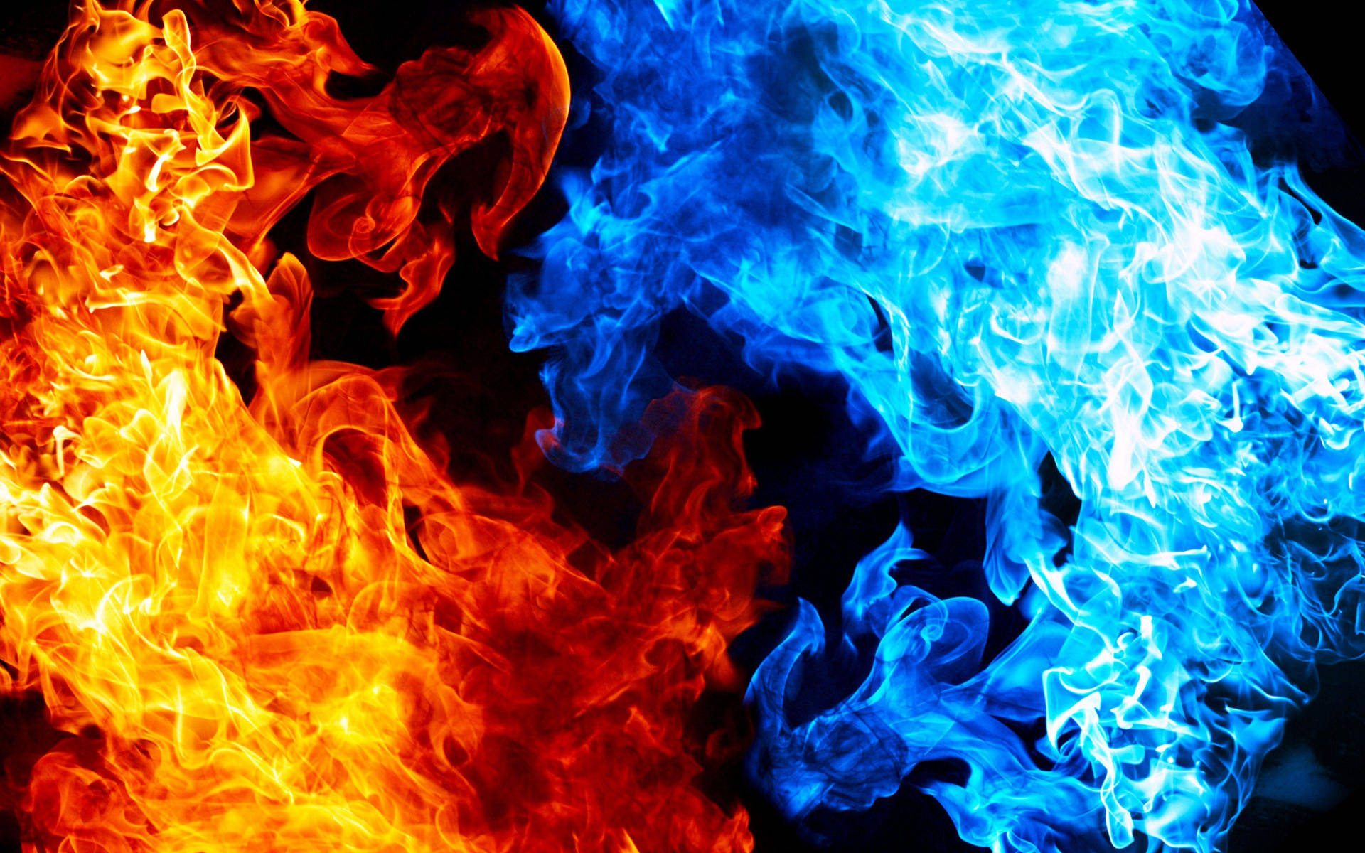 Caption: Mesmerizing Dance of Blue and Orange Flames Wallpaper
