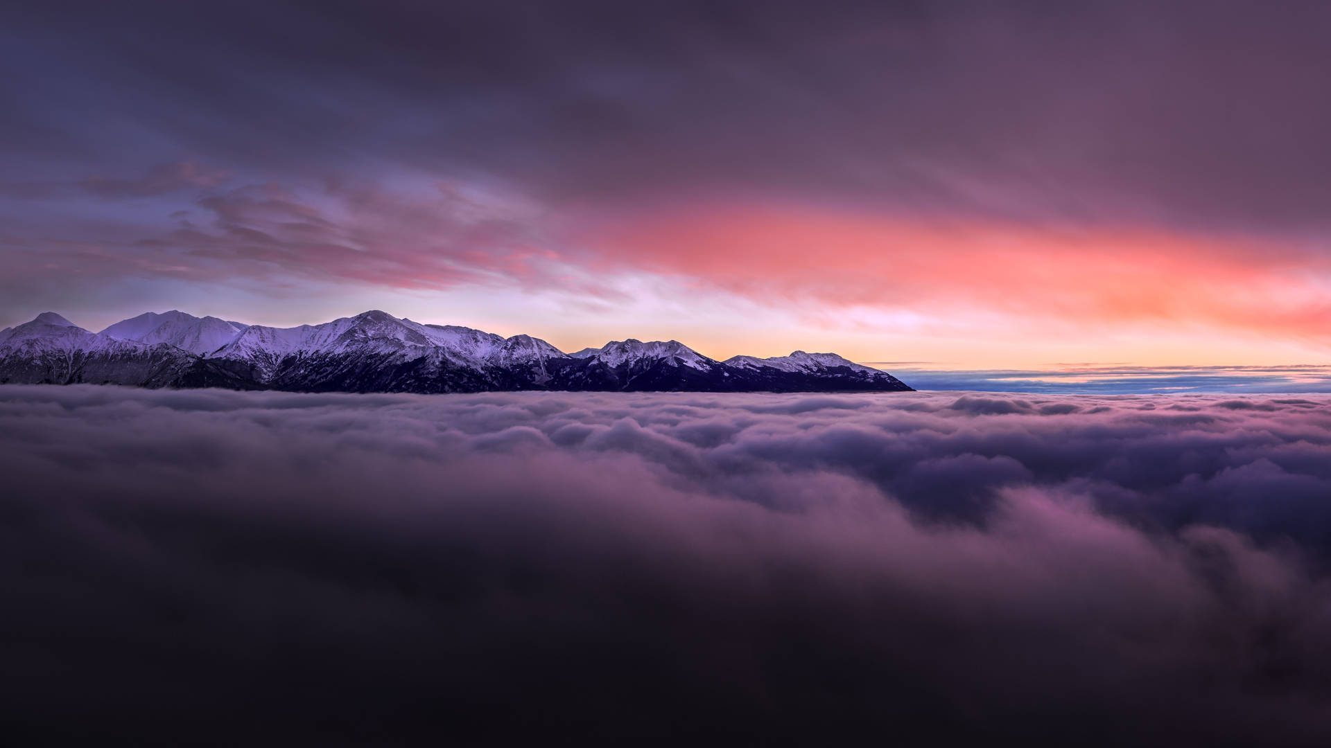 A view of the sky with contrast of vibrant purple and white clouds. Wallpaper