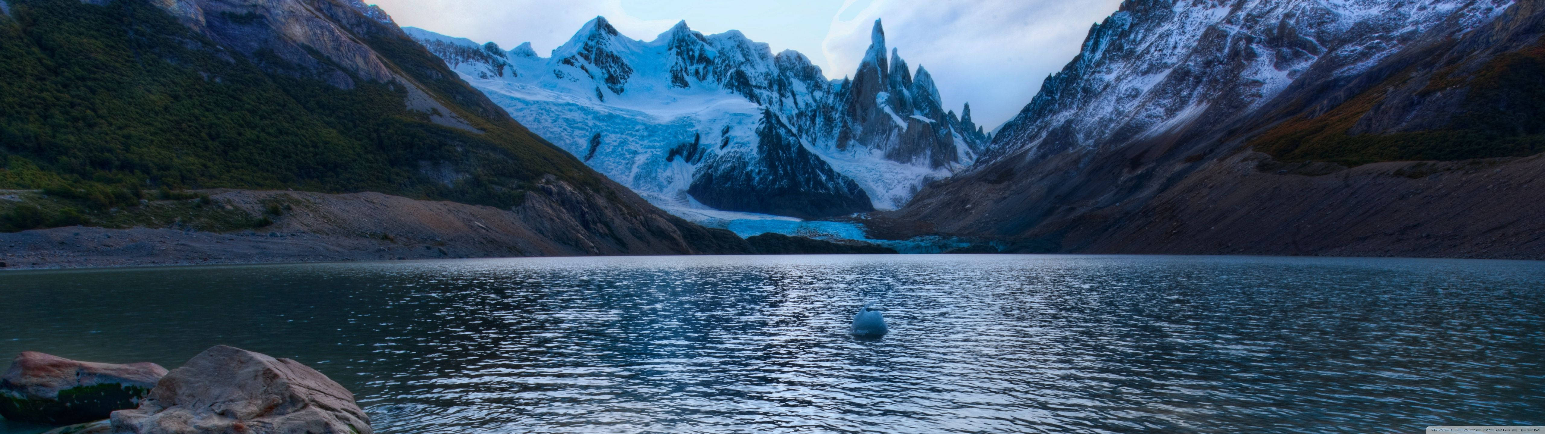 "An Aerial View of Majestic Mountains and Expansive Water" Wallpaper