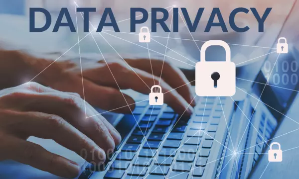 fingers on a laptop keyboard typing; text reads DATA PRIVACY. Locks connected by lines overlay the scene.